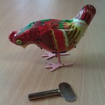 Wind-up Toy - this is chicken is made of tin, and has a simple clockwork mechanism inside it that would be wound with a key. The chicken then hops around and pecks at the floor. It is made from folded thin pieces of tin that have quite sharp edges.